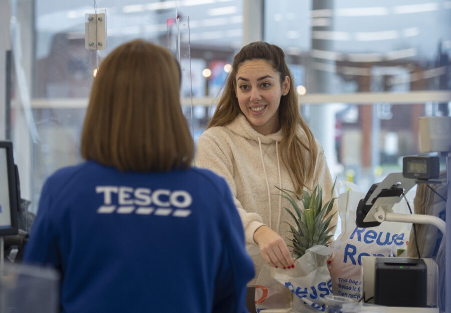 A woman at a Tesco checkout.