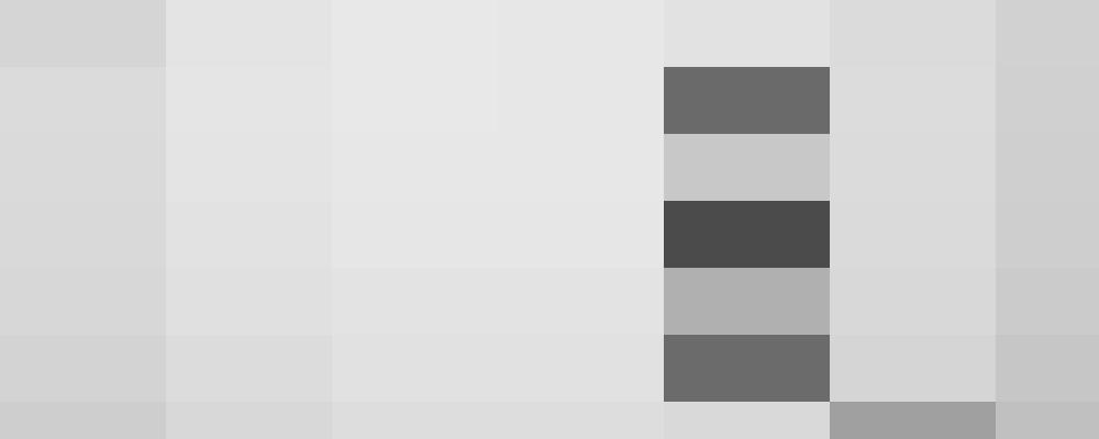 A man with short hair wearing a striped shirt looks slightly off-camera while smiling, exuding confidence as though he's ready to tackle any HR challenge. The background is plain, adding to the timeless feel of the black-and-white image.