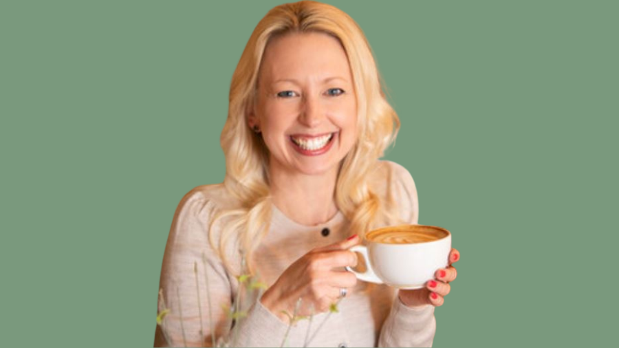 A person with long blonde hair is smiling and holding a white cup filled with a hot beverage, enjoying a moment of HR looking after itself, against a plain green background.