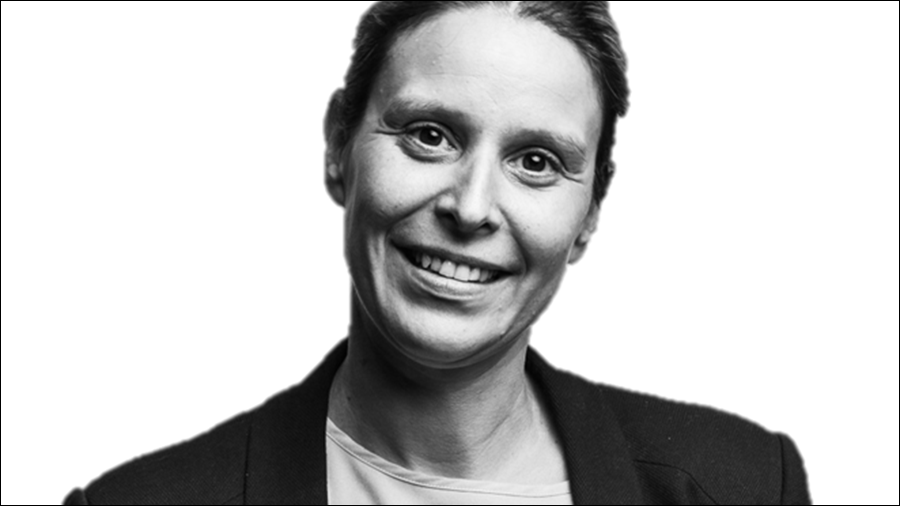 Black and white headshot of a person with short hair, wearing a blazer and smiling at the camera—an ideal image for any HR personnel directory.
