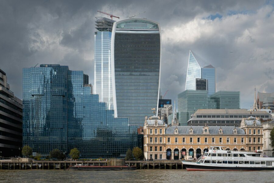 A view of the London City financial district with the river Thames in the foreground.