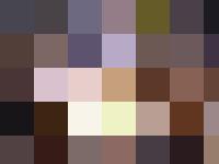 Personnel are managing the assembly line of a car manufacturing process.