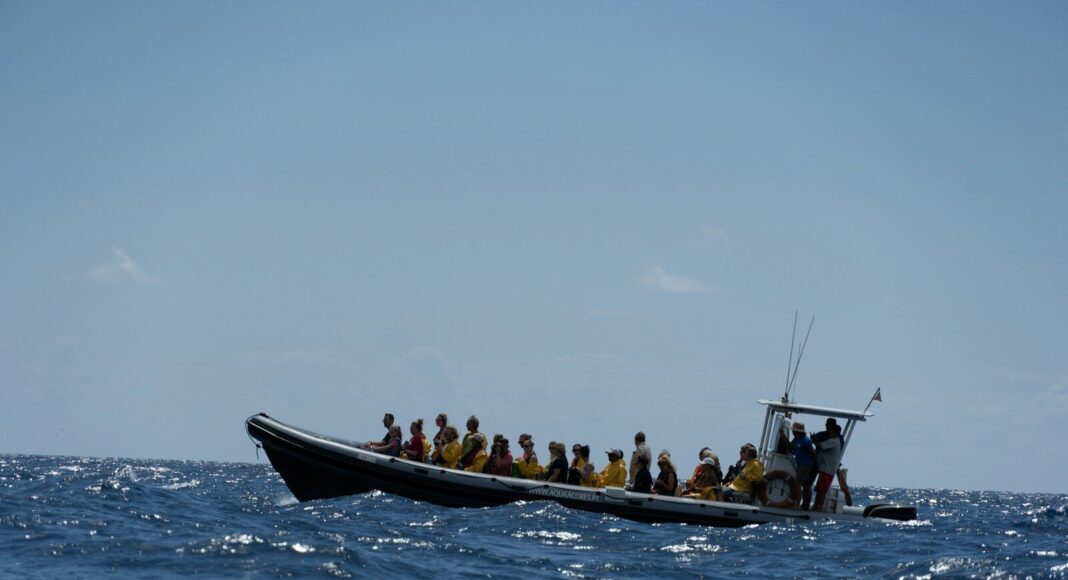 A boat carries migrants in the sea.