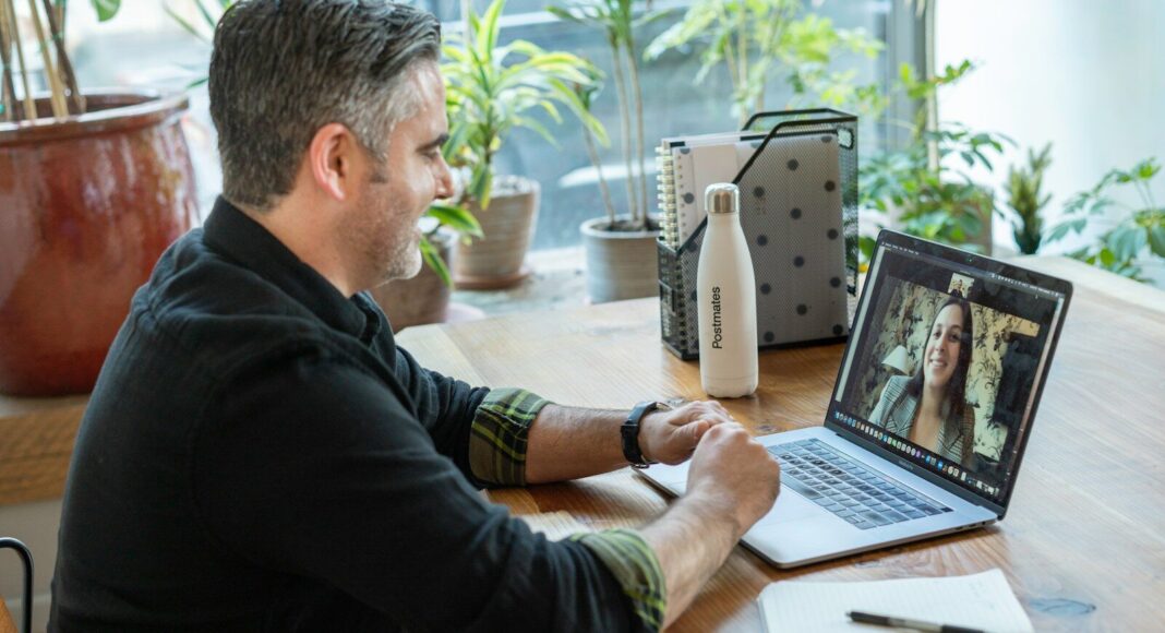 A man working on a laptop in a home setting.