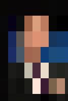 A man in a suit and tie is speaking into a microphone during an HR conference.