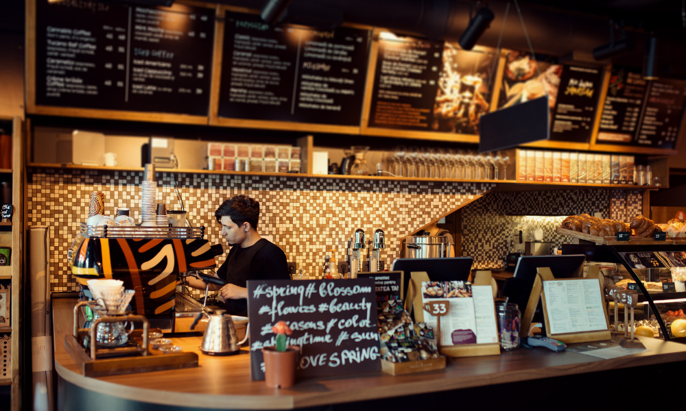 a man in a coffee shop behind the counter