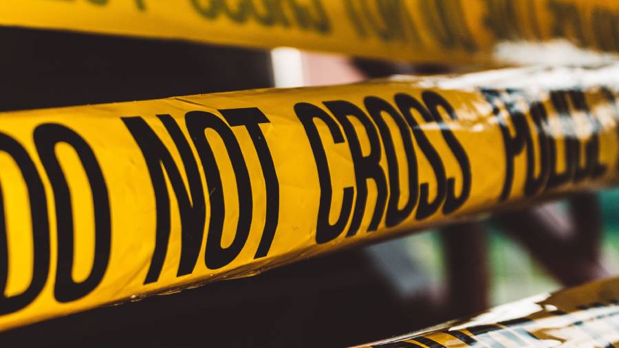 Close-up of yellow police tape with the text 