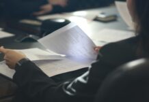 Up to 28,000 employees affected by paper-based data breaches A person reads paper documents at a desk.