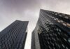 AI adoption accelerates as employers rethink workforce size A view from ground level of skyscrapers in Manchester, UK.