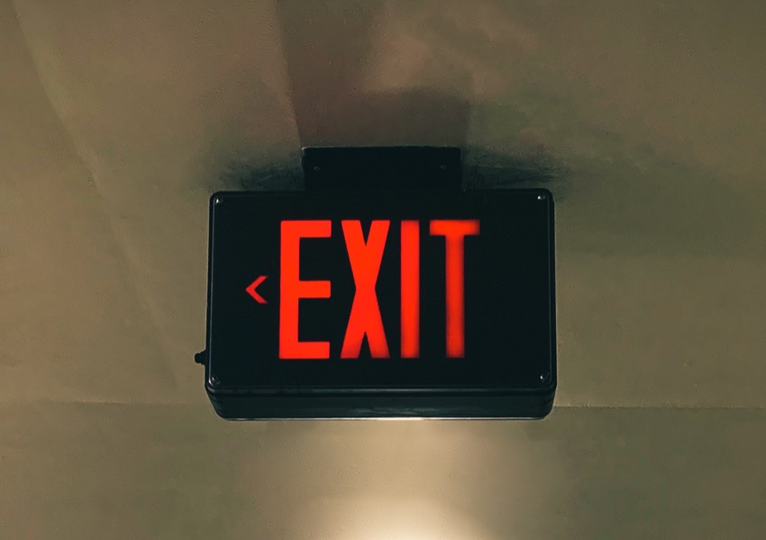 A black exit sign with the word 