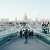 People walking across a bridge in London.