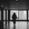 A person walking down a hallway in a building.