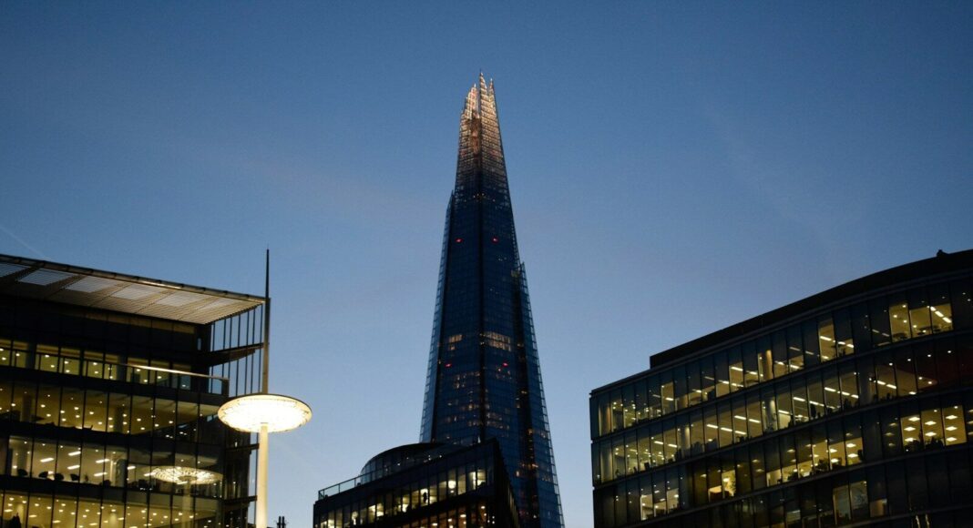 Photo by André Eusébio The Shard towers above other London office buildings at dusk.