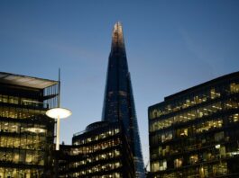 Pay awards rise to 3.2% as employers balance caution with hiring pressures The Shard towers above other london buildings at dusk.