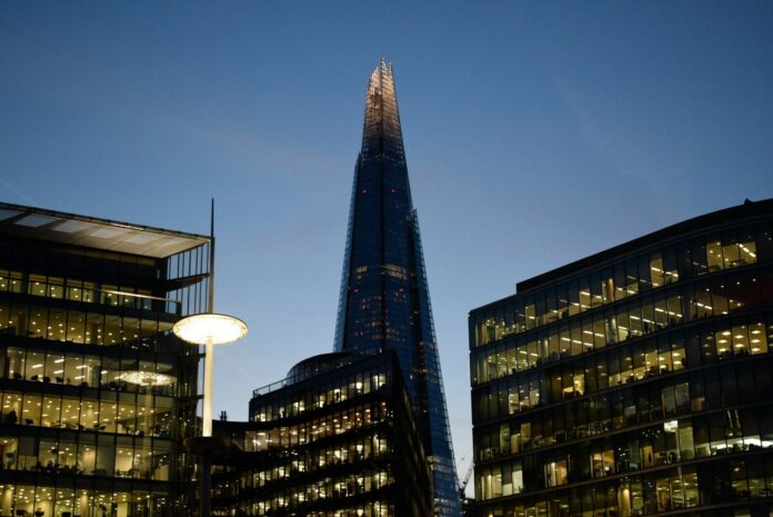 Photo by André Eusébio The Shard towers above other london buildings at dusk.