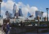 Treasury watchdog warns higher taxes risk hitting labour supply A man in a blue suit and backpack walks along the Thames, with City of London skyscrapers in the background.
