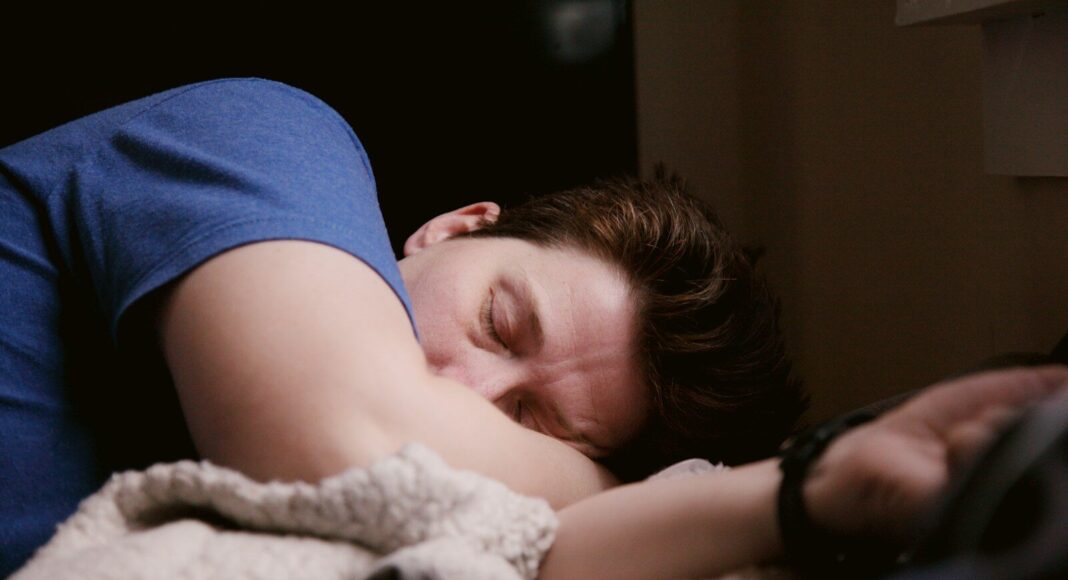 A person lying on a bed.