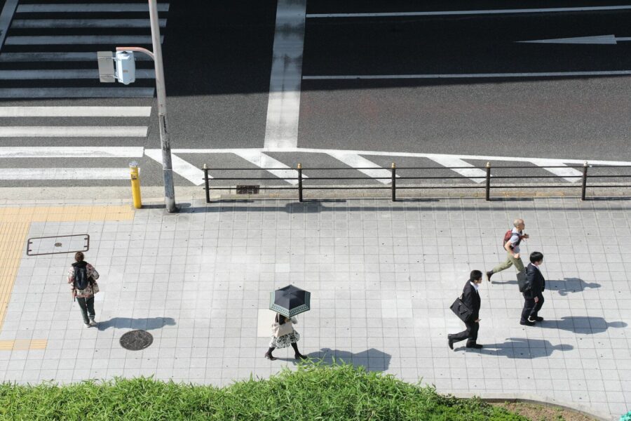 Businesspeople in suits walking by office buildings.