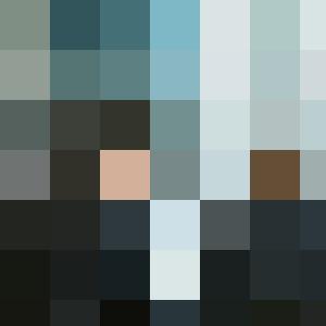 Two business people engaging in conversation at a table in an office, discussing internal branding strategies.