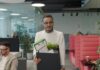Knowledge workers ‘eye career exits’ as AI fears grow A man carries a box of personal items as he leaves an office after quitting.