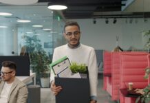 Knowledge workers ‘eye career exits’ as AI fears grow A man carries a box of personal items as he leaves an office after quitting.