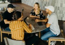 Guaranteed hours reforms could reduce hiring and hurt young workers, employers warn A group of young people working with laptops at a table.