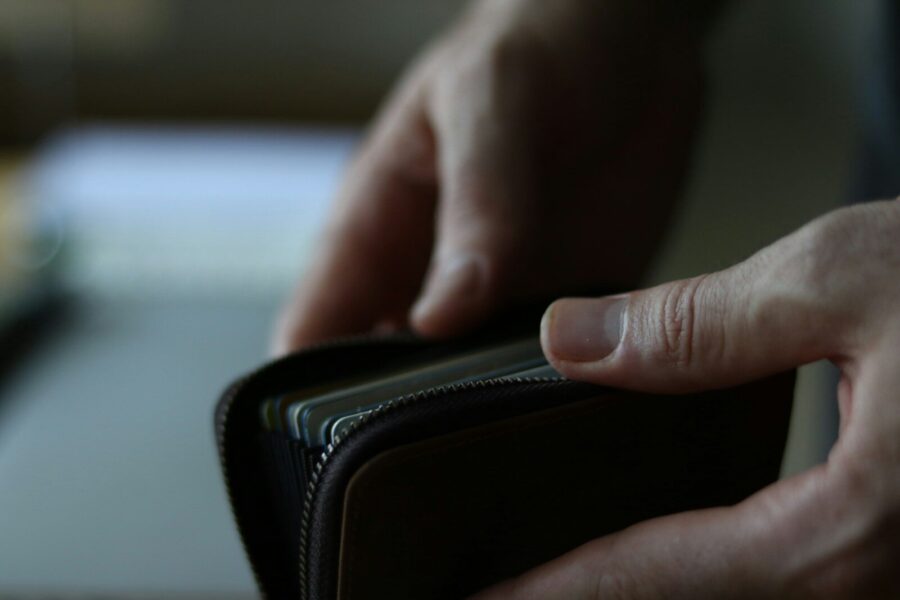 A person holding a wallet in their hand.