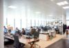 Most organisations lack a strategy to communicate workplace change: report Staff working at desks in an open-plan office.