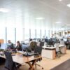 People working at desks in an open office.