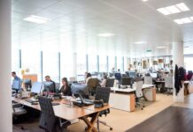 Employees opting for home working ‘to escape noisy offices’ People working at desks in an open office.