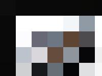 A group of personnel sitting around a conference table.