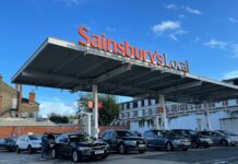Britain’s biggest retailers cut 18,000 jobs as employment costs rise Cars parked under a Sainsbury's supermarket sign.