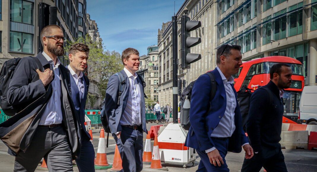 Photo by martin fenton Men in suits walking along a city street.