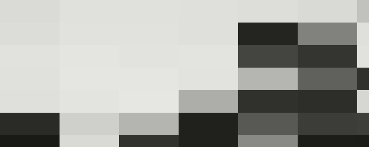 A man stands next to a wire fence on a street with industrial buildings and chimneys in the background, perhaps pondering personnel matters crucial for effective human resources.