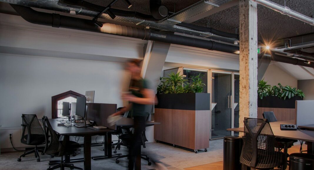 Photo by Rodeo Project Management Software A blurry photo of a man in an office.