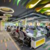 A large open office space with many desks and chairs