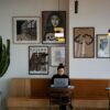 A woman works on a laptop in a cafe.