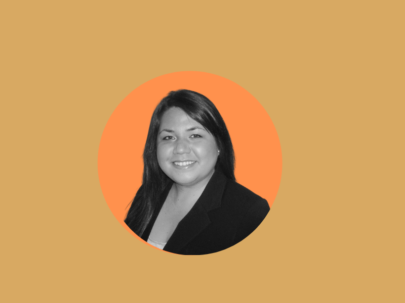 Black and white portrait of a person with long dark hair wearing a blazer, set against an orange circular background, resembling a hybrid model of classic and contemporary aesthetics.