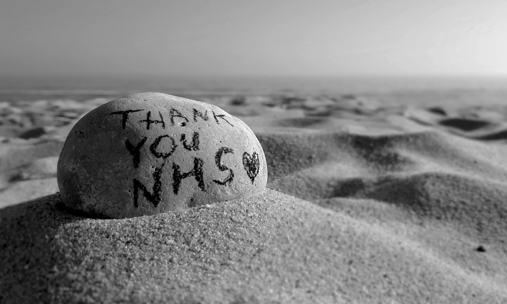 A rock on a sandy beach with 