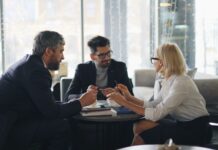 Succession planning gaps ‘leave firms scrambling for senior HR talent’ Business executives meeting around a table.