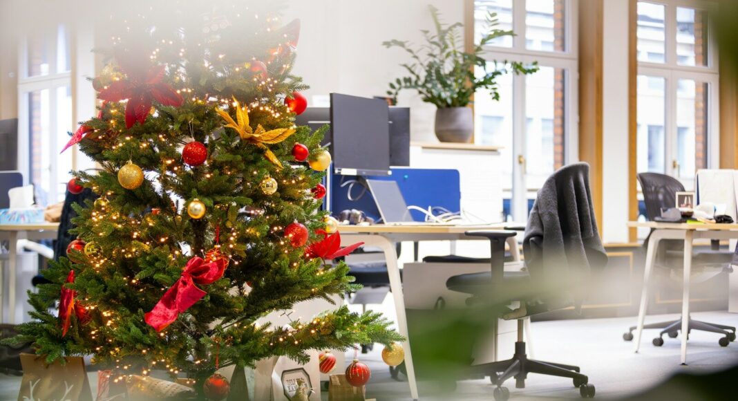 A decorated Christmas tree in an office.
