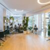 People working in an open-plan office, with some chairs empty.