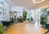 Four-day week gains ground as companies report lower burnout and stable productivity People working in an open-plan office, with some chairs empty.