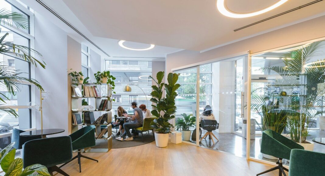 People working in an open-plan office, with some chairs empty.