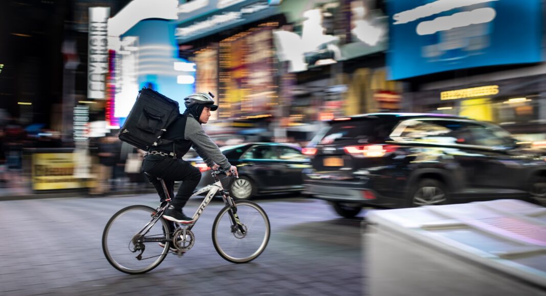 A person riding a bike to make a delivery,