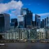 Modern skyscrapers rise above the river Thames in london.