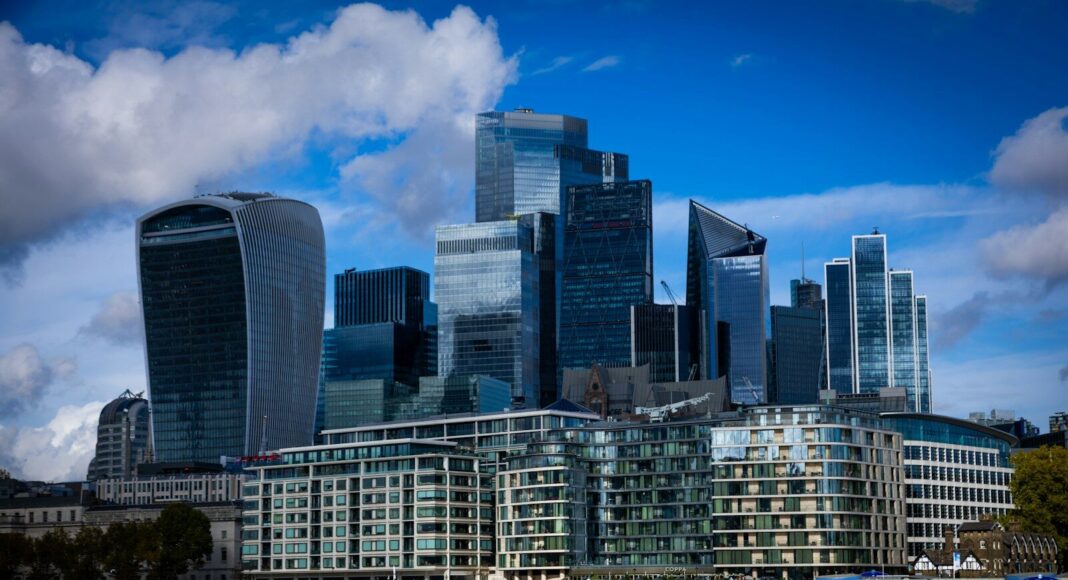Modern skyscrapers rise above the river Thames in london.