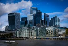 Business failures leave £32.6m in unpaid pensions as insolvencies surge Modern skyscrapers rise above the river Thames in london.