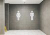 Major employers face scrutiny over workplace toilet policies after court ruling Men's and women's signs outside a toilet.