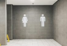 Major employers face scrutiny over workplace toilet policies after court ruling Men's and women's signs outside a toilet.